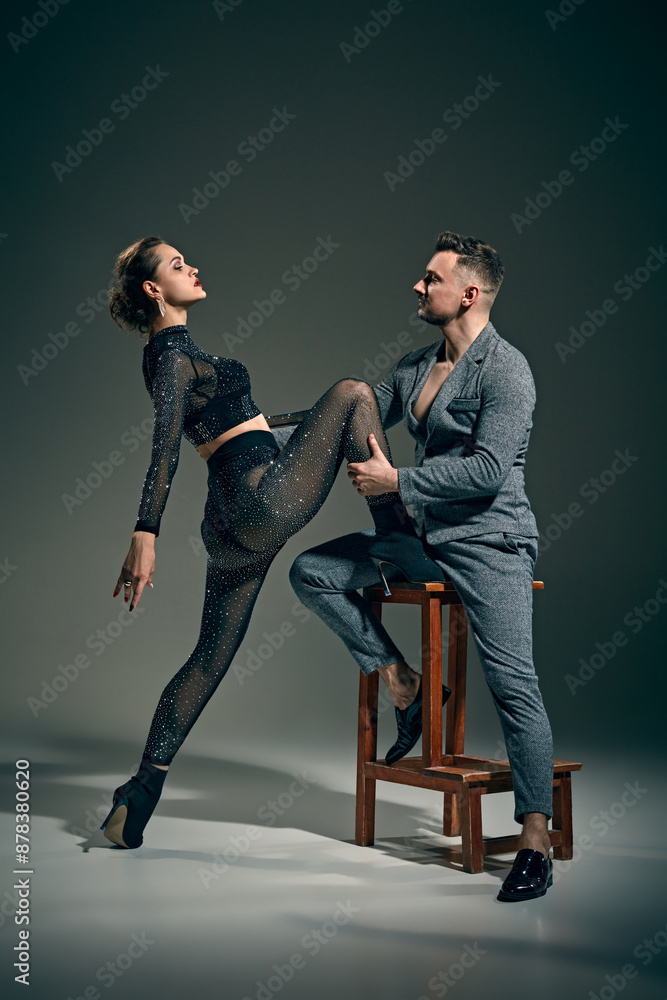 Portrait of elegant young woman and man, passionate dancers performing bachata, posing again vintage green background. Concept of dance, performance, art, emotions, entertainment Portrait of elegant young woman and man, passionate dancers performing bachata, posing again vintage green background. Concept of dance, performance, art, emotions, entertainment