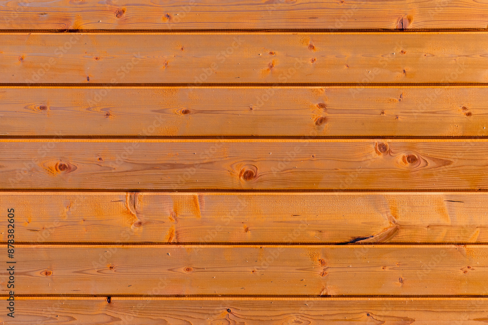 Wooden wall made of toned pine wood boards, frontal view Wooden wall made of toned pine wood boards, frontal view