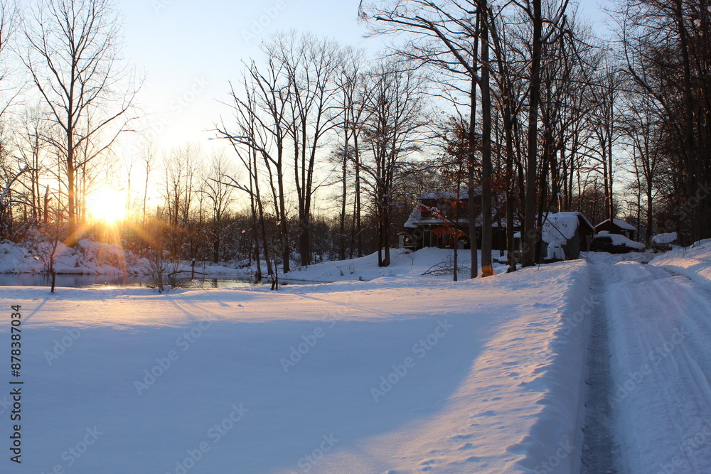 Fototapeta premium winter sunset at cabin in the woods