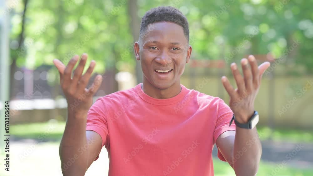 Inviting Gesture by Casual African Man Standing Outdoor Inviting Gesture by Casual African Man Standing Outdoor