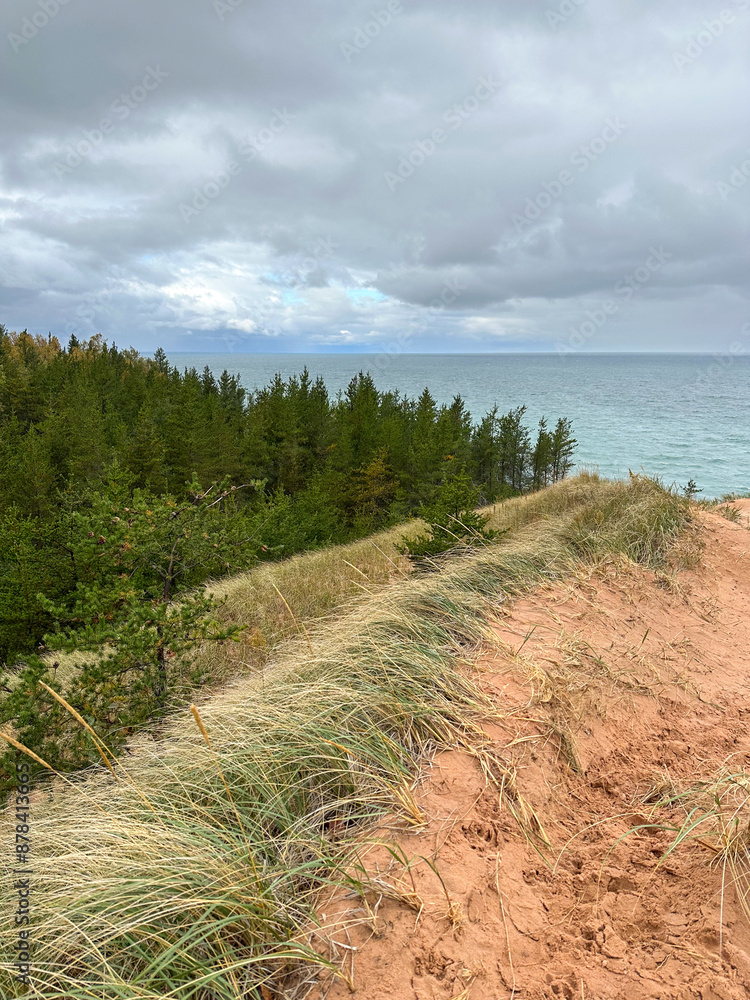 Sand dunes with and overcast sky and turquoise Lake Superior