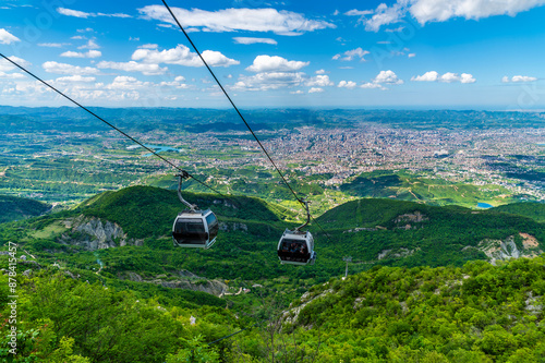 Tableau sur toile A view on Dajti mountain of cable cars approaching the  terminal above Tirana, A