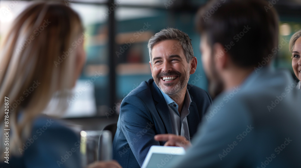 Man smiles, talks to women in meeting Man smiles, talks to women in meeting