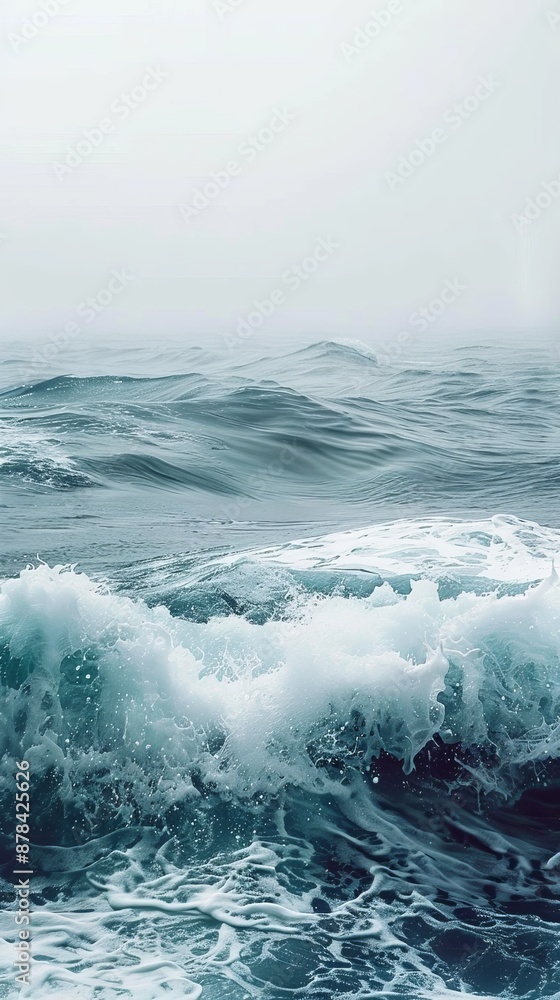 Obraz premium Building ocean waves crash, creating mesmerizing sea foam on dark sea. Powerful crashing waves add dramatic touch to serene seascape