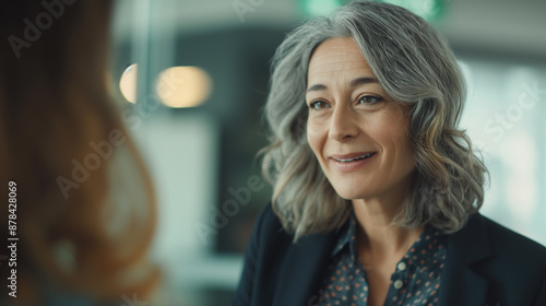 A woman with gray hair in black jacket
