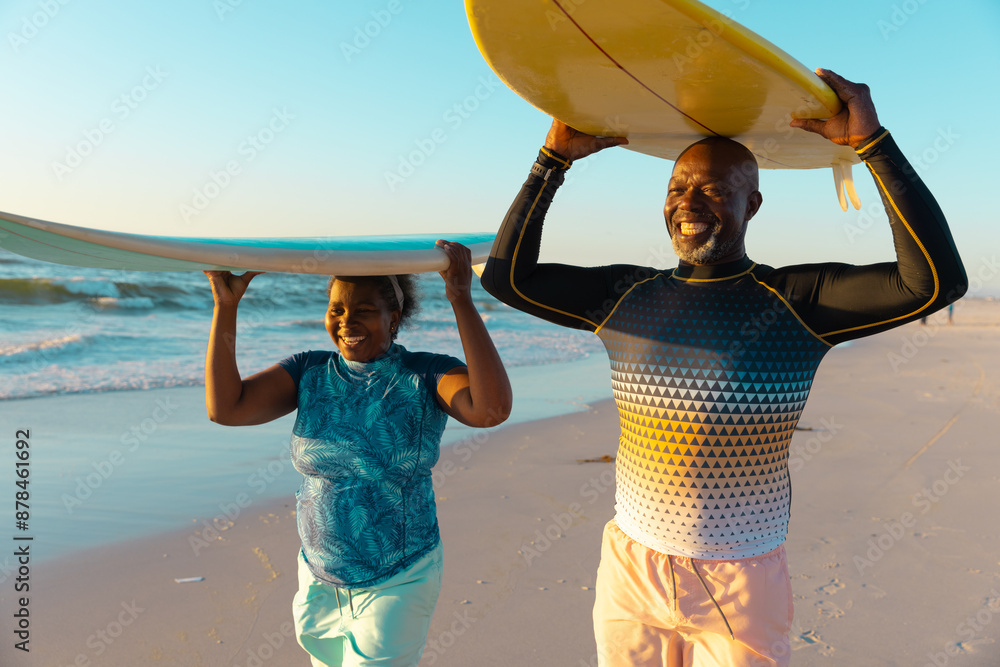 Obraz premium Senior African American couple enjoys a beach day, with copy space