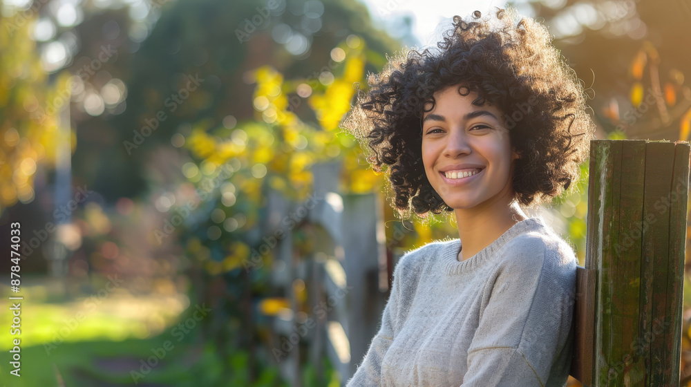 Happy Woman with Curly Hair Smiling Outdoors in Sunny Garden Happy Woman with Curly Hair Smiling Outdoors in Sunny Garden