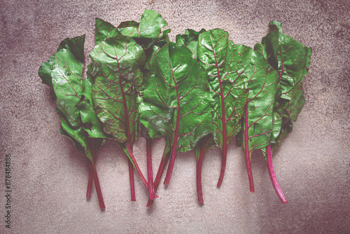 fresh, green leaves, stem with beet leaves, on the table, top view, rustic, no people, photo