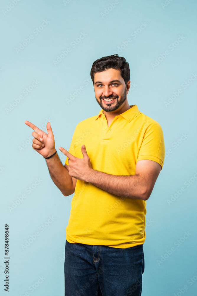 Happy Indian Asian Bearded Man Pointing at Copy Space, Looking Shocked, Blue Background Happy Indian Asian Bearded Man Pointing at Copy Space, Looking Shocked, Blue Background