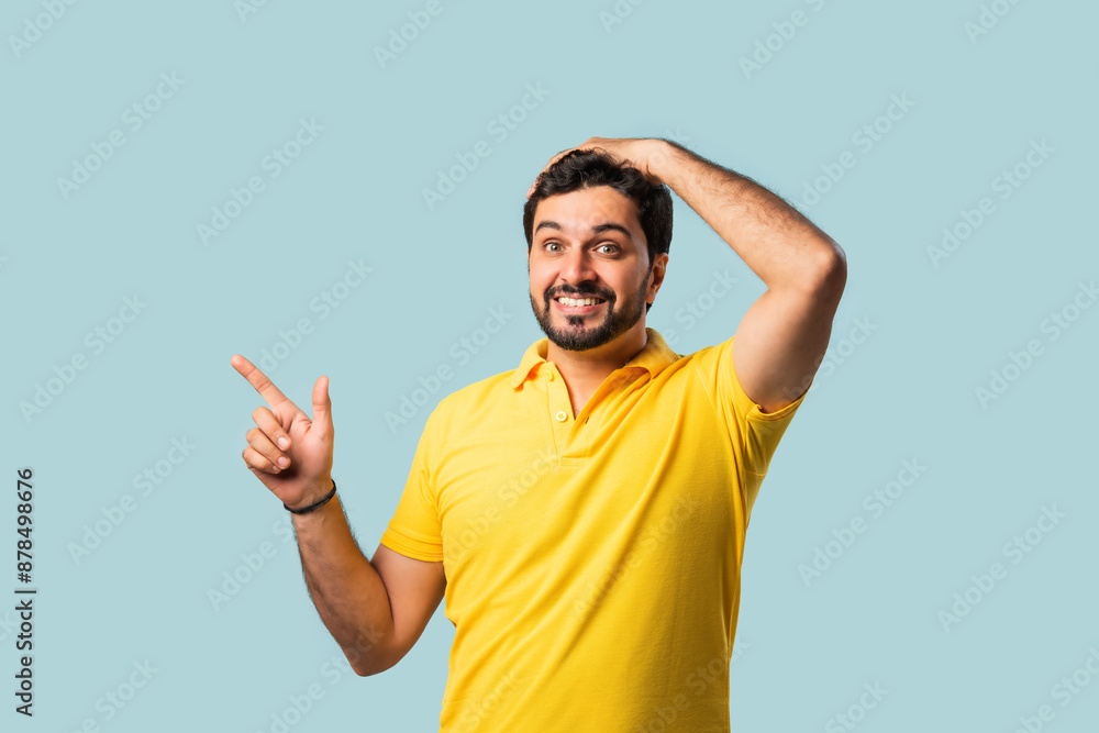 Happy Indian Asian Bearded Man Pointing at Copy Space, Looking Shocked, Blue Background Happy Indian Asian Bearded Man Pointing at Copy Space, Looking Shocked, Blue Background