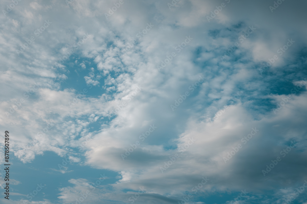The sky is blue with a few clouds scattered throughout. The clouds are white and fluffy, giving the sky a peaceful and serene appearance The sky is blue with a few clouds scattered throughout. The clouds are white and fluffy, giving the sky a peaceful and serene appearance