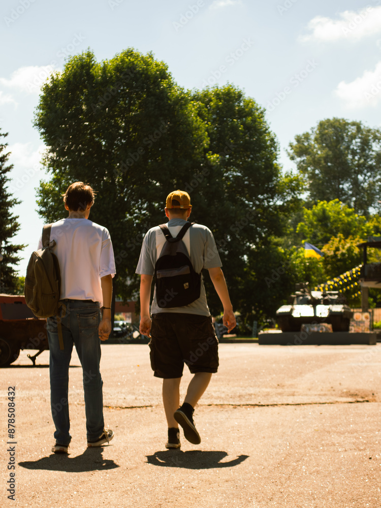 Guys walking towards a tank Guys walking towards a tank