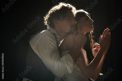 Photography A good-looking man and woman passionately hug during theater rehearsals