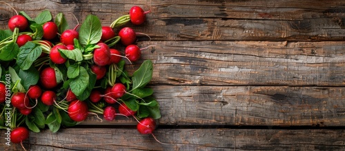 Fresh red radishes arranged on an aged wooden table with a blank space for copy in the image.