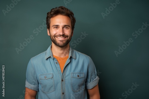 Portrait of a grinning man in his 30s sporting a versatile denim shirt isolated in pastel or soft colors background © Markus Schröder