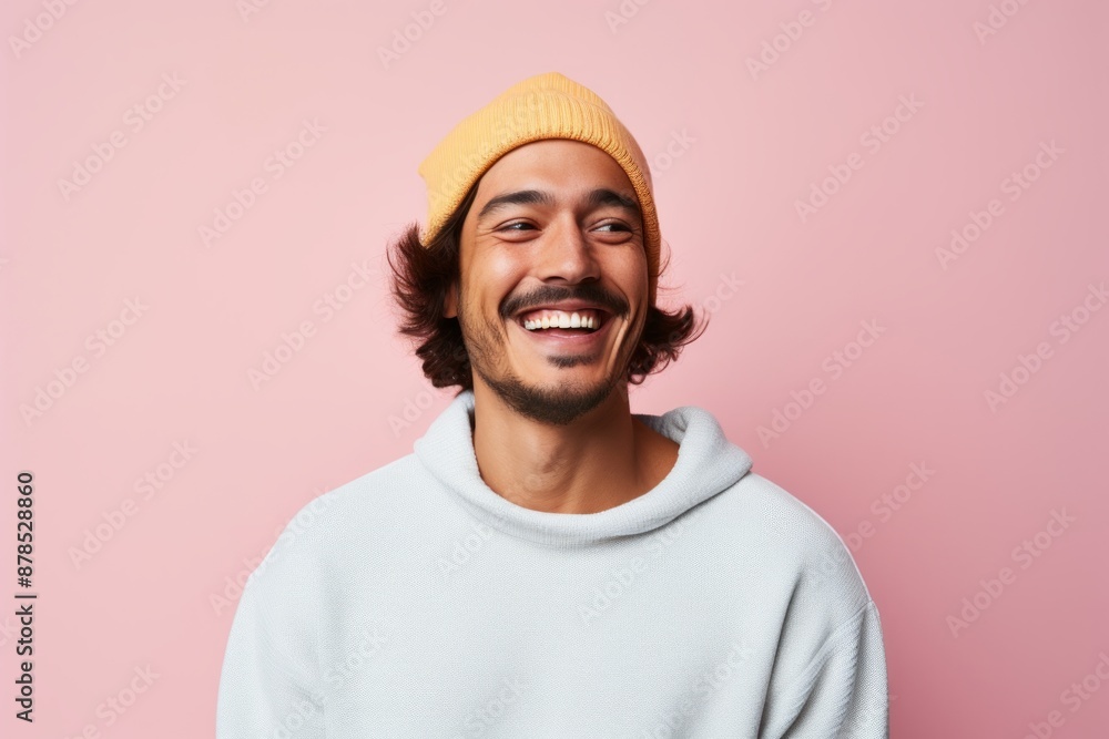 Portrait of a smiling man in his 30s sporting a trendy beanie in front of pastel or soft colors background Portrait of a smiling man in his 30s sporting a trendy beanie in front of pastel or soft colors background