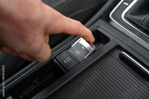 Close-Up of Electronic Parking Brake Control: Modern Vehicle Interior with High-Tech Parking Feature