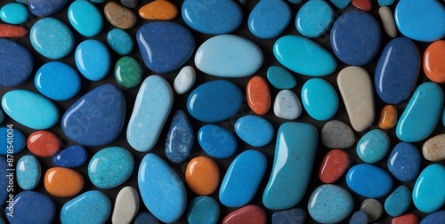 Vibrant Collection of Polished Stones: A Colorful Mosaic of Blue, Orange, Red, and Grey