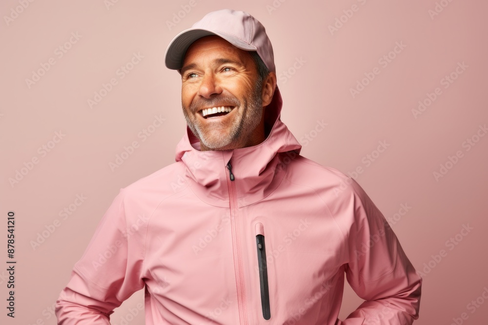 Portrait of a joyful man in his 40s wearing a windproof softshell isolated on pastel or soft colors background Portrait of a joyful man in his 40s wearing a windproof softshell isolated on pastel or soft colors background