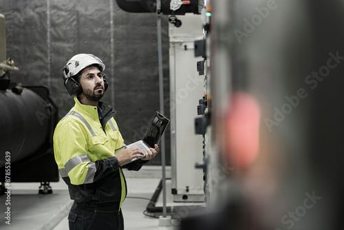 electrician working in a factory. electrician at work. electrician working in a power station. engineer working on the checking status switchgear electrical energy distribution substation.