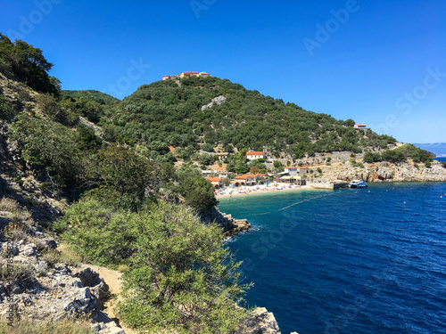 view of the sea and mountains and a small town