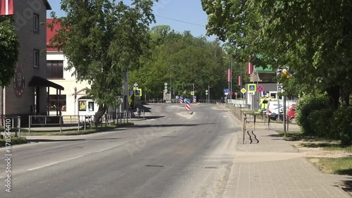 Balvi, Latvia - May 28, 2024 - Video of a quiet street in Balvi, Latvia, lined with buildings and trees, with visible traffic signs and a few vehicles. photo