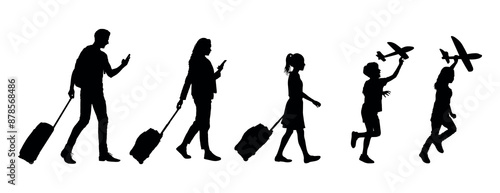 Couple tourist pullling their suitcase and their children playing with toy airplane on holiday trip side view silhouettes.