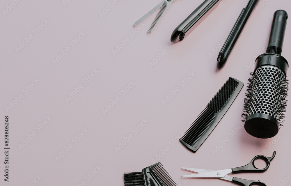 Scissors, combs, brushes and a hair straightener on a pale pink background. Scissors, combs, brushes and a hair straightener on a pale pink background.