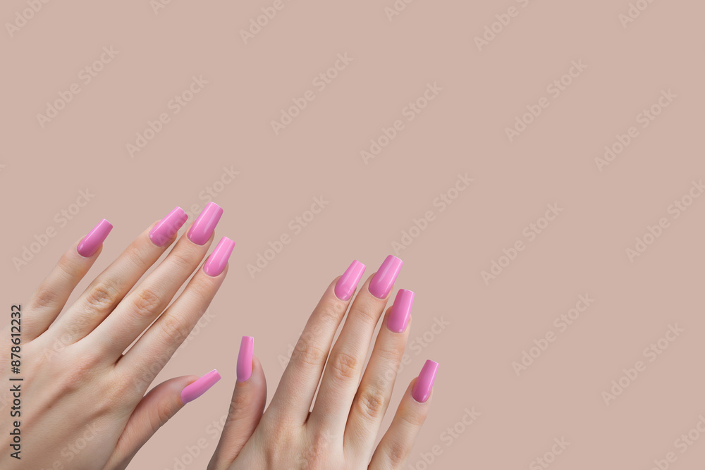 Pink Nail Polish on Female Hands with Long Nails. Female hands with long, pink nail polish on a matching beige background. Pink Nail Polish on Female Hands with Long Nails. Female hands with long, pink nail polish on a matching beige background.