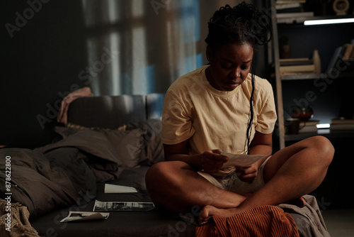 Photos Sad African American woman looking at picture of her sweetheart or died relative