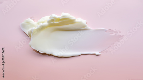 Texture of cosmetic butter on a pink background. photo