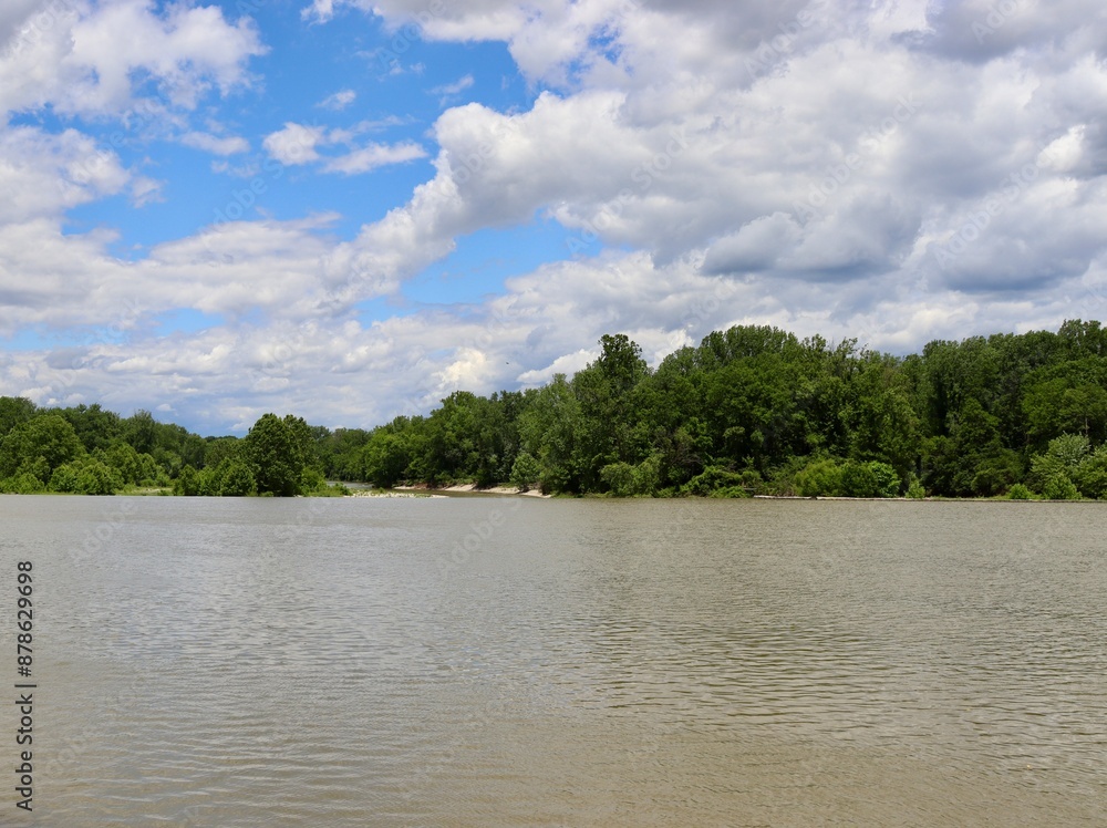 The flowing river in the countryside on a sunny day.