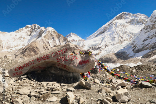 At the Base Camp of Mount Everest, a large rock, sprayed with red graffiti, paint marks the site in front of Mount Khumbutse, Changtse, the West Ridge of Everest and Everest, EBC, Nepal  photo