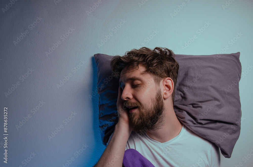 © phoenix021 - Mans sound asleep on a pillow, resting, side view of his head