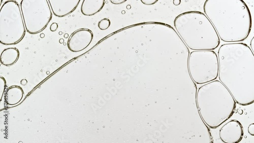 Transparent cosmetic gel fluid with molecule bubbles oil distribution. Bubble cluster, cells under a microscope. Macro Shot of Natural Organic Cosmetics, Medicine. Production Close-up. Slow Motion. 4k