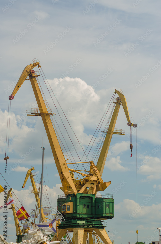 Working port cranes. Unloading and loading of goods at the port. High quality photo Working port cranes. Unloading and loading of goods at the port. High quality photo