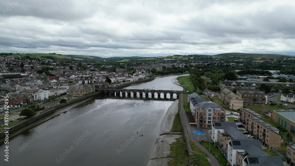 Barnstaple, Devon, England: DRONE VIEWS: Long Bridge spanning the River Taw in central Barnstaple. The medieval bridge reflects the town's early history as a prosperous wool trading centre (Clip 8). Barnstaple, Devon, England: DRONE VIEWS: Long Bridge spanning the River Taw in central Barnstaple. The medieval bridge reflects the town's early history as a prosperous wool trading centre (Clip 8).
