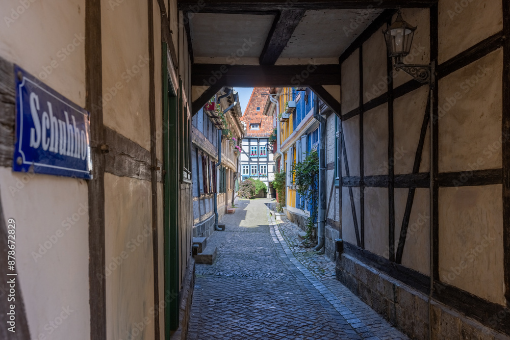 Fototapeta premium Passage and half-timbered houses in the Alley called Schuhhof (shoemakers court) in the old city of Quedlinburg, Saxony-Anhalt, Germany