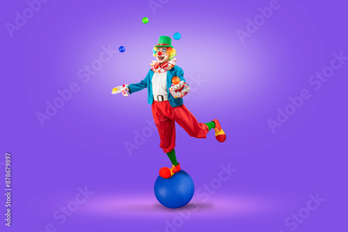 Funny juggler clown juggling balls in the circus, man entertainer as Joker in a suit and wig, with clown whiteface makeup. Trickster, jester, pantomime, mime, and a professional actor at events.