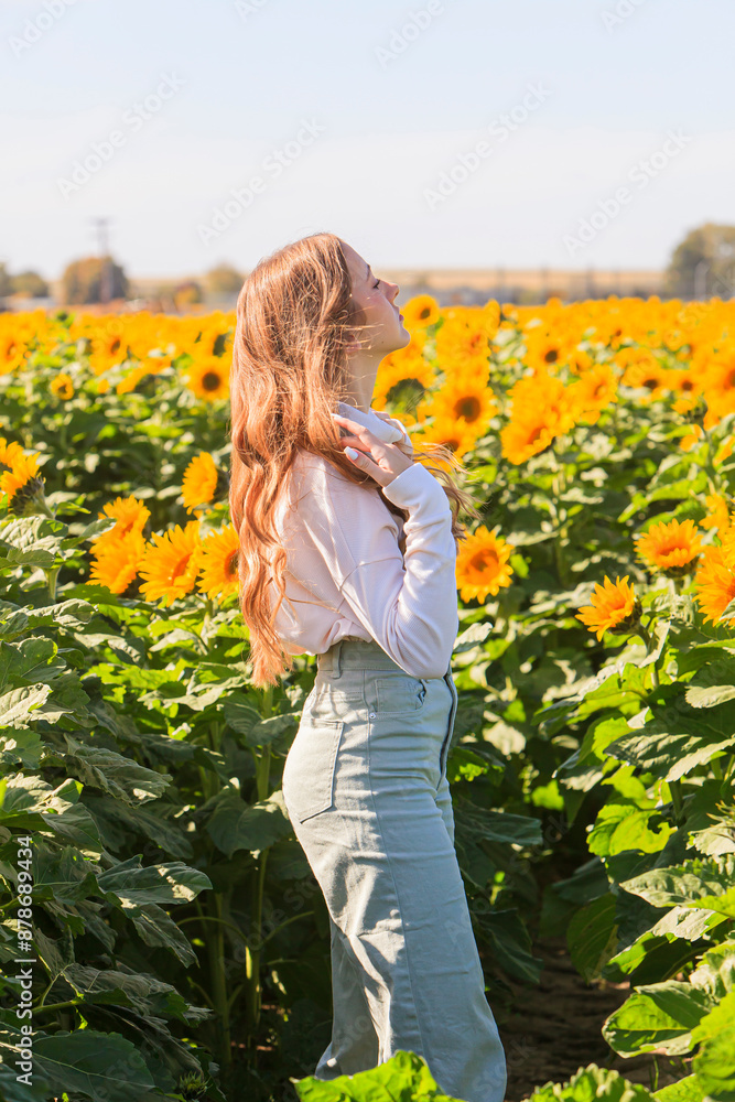 Happy blonde teenage girl in sunflower field. Happy blonde teenage girl in sunflower field.