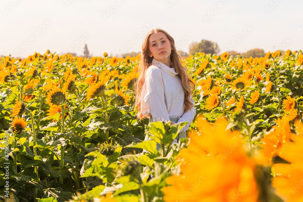 Happy blonde teenage girl in sunflower field. Happy blonde teenage girl in sunflower field.
