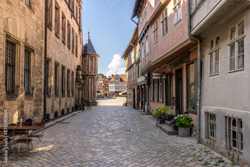 Alley leading to the main square (Marktplatz) in the old city of Quedlinburg,Sacony-Anhalt, Germany. To the left a side view of the old city hall