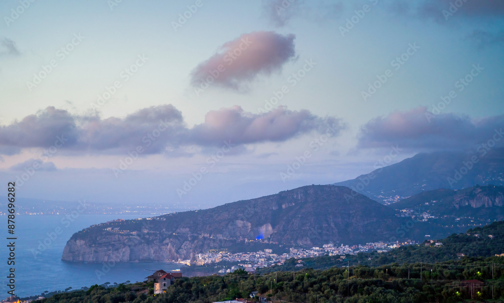 Twilight Over the Sorrento Coastline - A stunning view of the Sorrento coastline at twilight, with distant city lights.