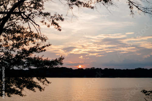 Beautiful sky and lake with boats, people relaxing on the shore at sunset. Beautiful orange and blue sky at dawn. Lake Bowen Anchor Park, Inman, SC, USA  photo