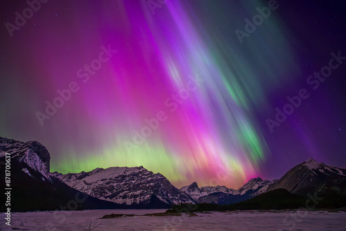 Aurora borealis painting the sky purple and green over snowy mountains