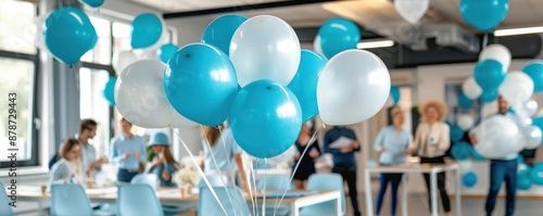 Office party decorated with blue and white balloons, colleagues socializing and enjoying the festive atmosphere