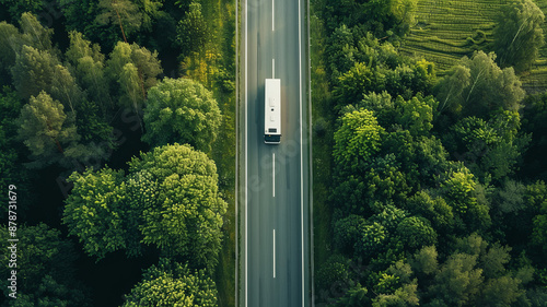 Obraz na płótnie an aerial shot of an empty road with a single bus driving - seen from above.generatiive ai w salonie