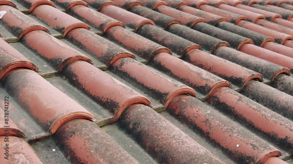 A close-up shot showcasing the intricate details of aged red roof tiles on an old house. The tiles have developed a natural patina over time, creating a beautiful and textured surface A close-up shot showcasing the intricate details of aged red roof tiles on an old house. The tiles have developed a natural patina over time, creating a beautiful and textured surface