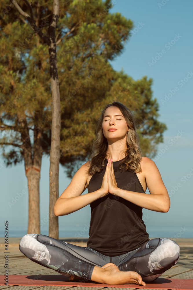 Female Practice Yoga Outdoors. young woman doing yoga position outdoors by a sea on a sunny day. morning meditation Female Practice Yoga Outdoors. young woman doing yoga position outdoors by a sea on a sunny day. morning meditation