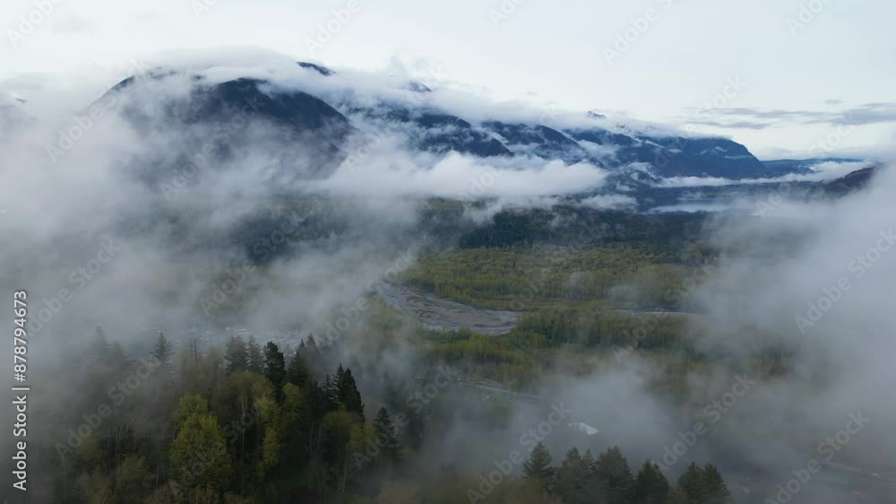Foggy, cloudy morning in the Fraser Valley. Trees, city and mountains. Spring season. British Columbia, Canada. Foggy, cloudy morning in the Fraser Valley. Trees, city and mountains. Spring season. British Columbia, Canada.